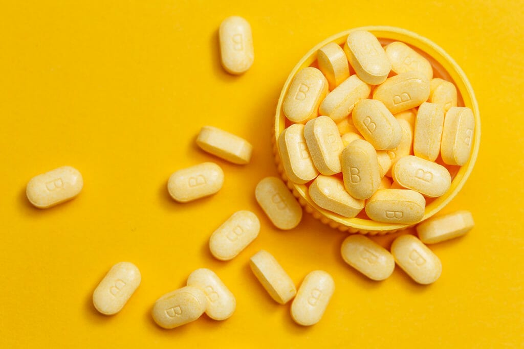 vitamin B tablets on yellow background